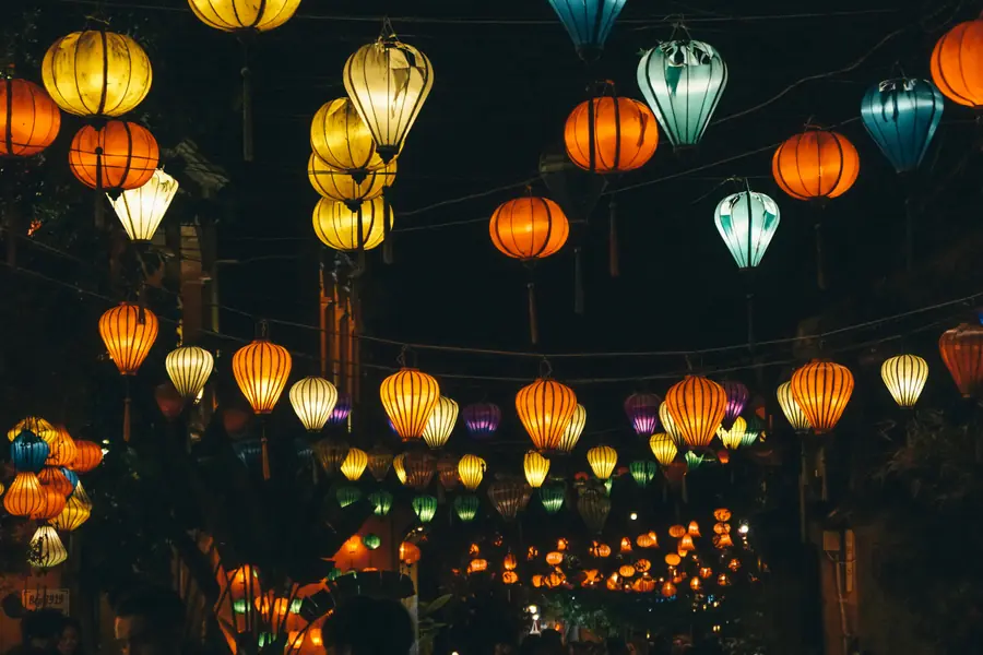 Lanternes colorées illuminant les rues pavées de Hoi An au crépuscule avec architecture sino-vietnamienne